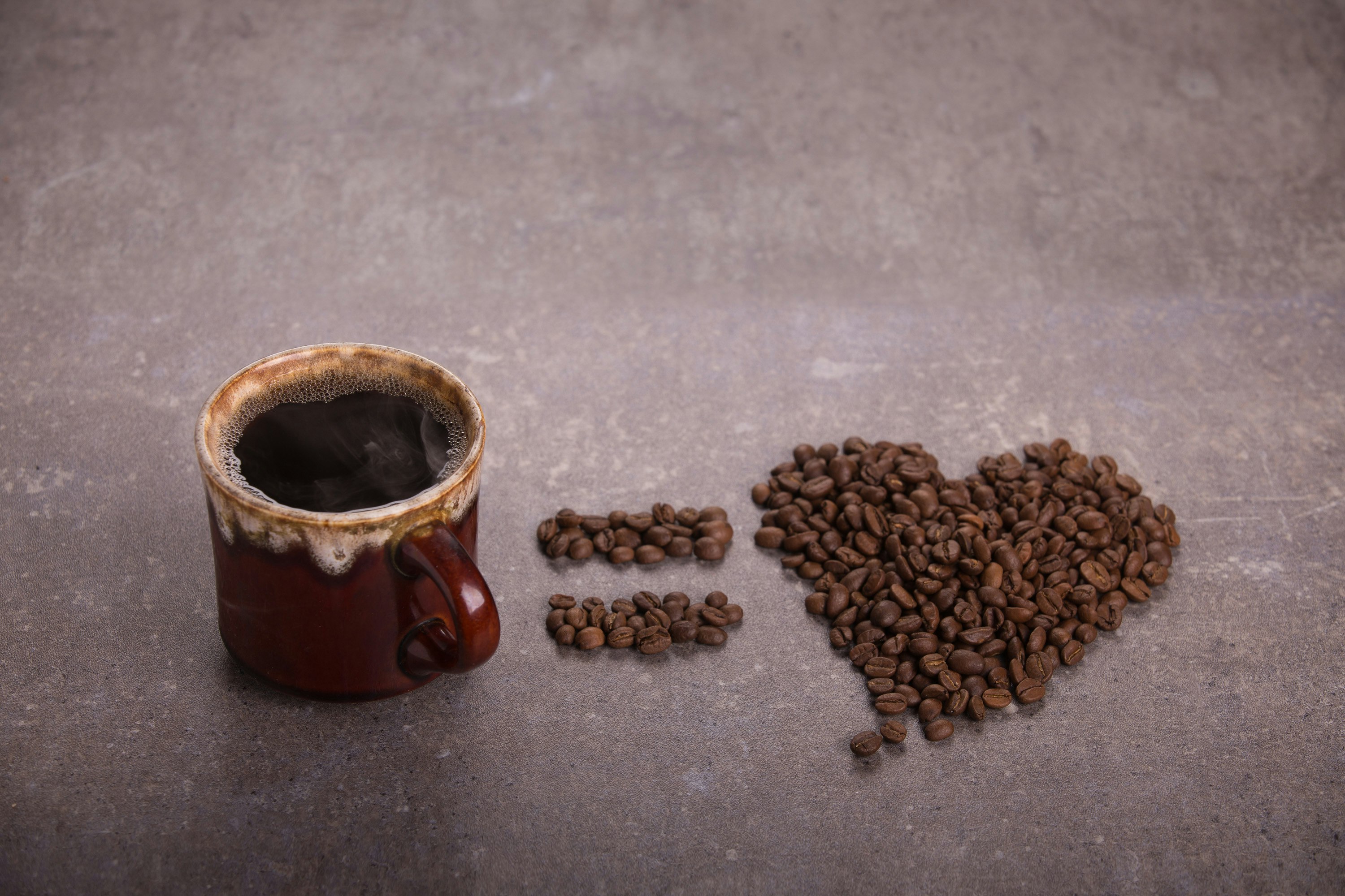 coffee bean beside brown ceramic mug